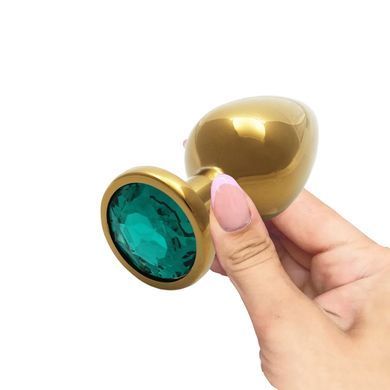 Металева анальна пробка Ouch! Round Gem M золотиста із зеленим кристалом 8,2 см - основне фото